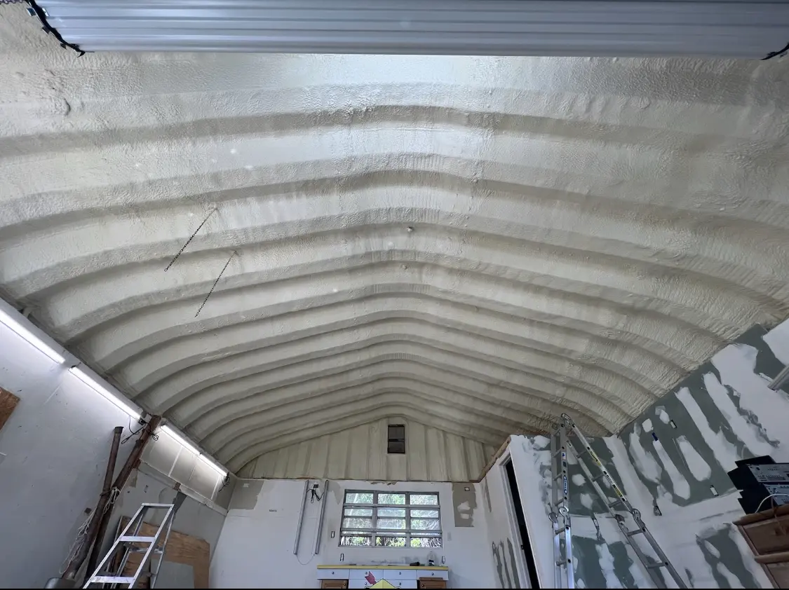 Spray polyurethane foam applied to the underside of a metal roof deck in Warwick